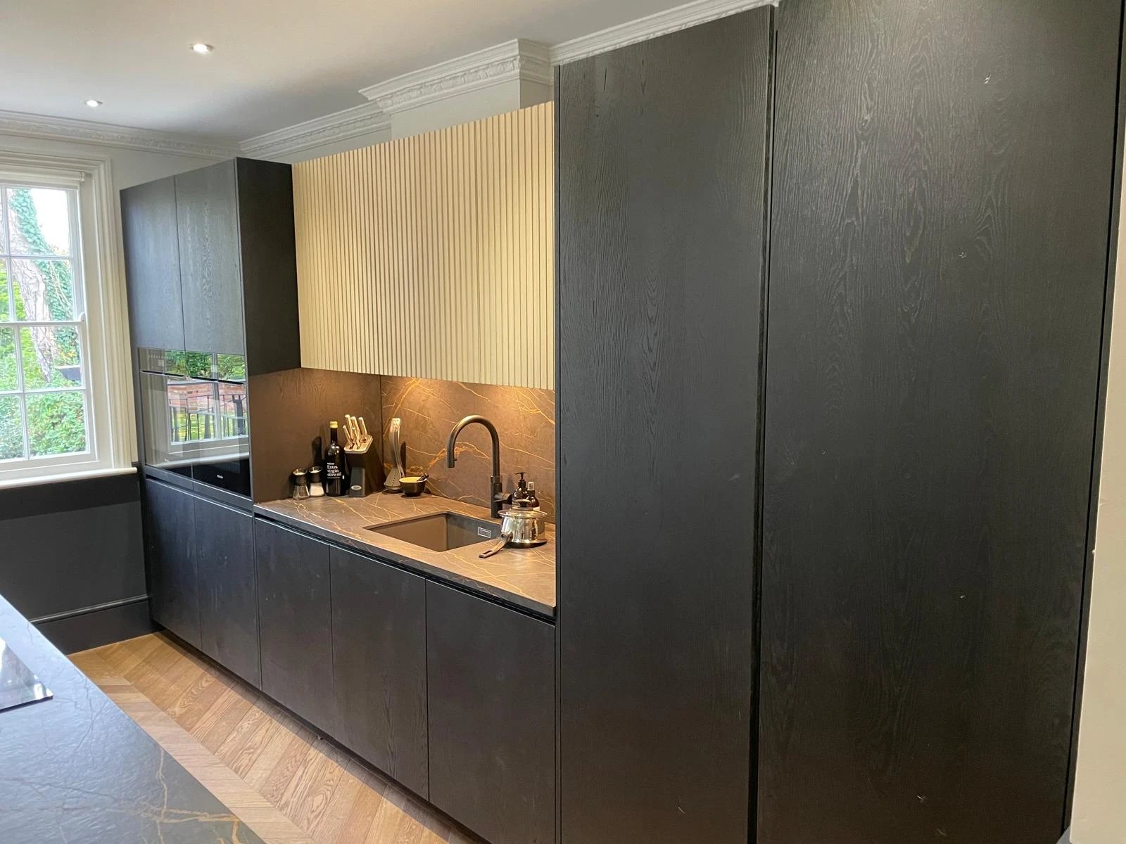 Black oak kitchen with fluted wall units