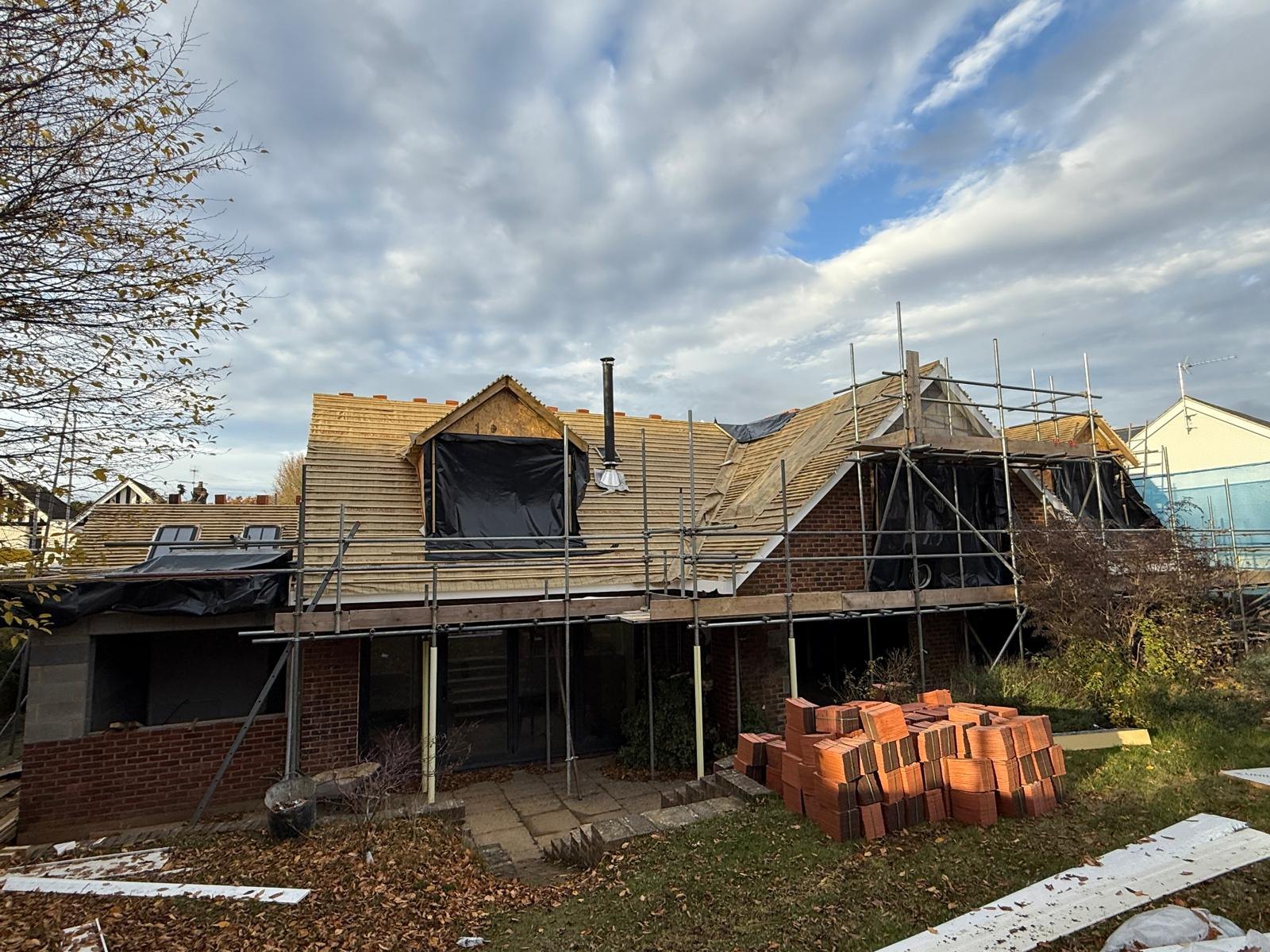 House under scaffold with a new loft dormer