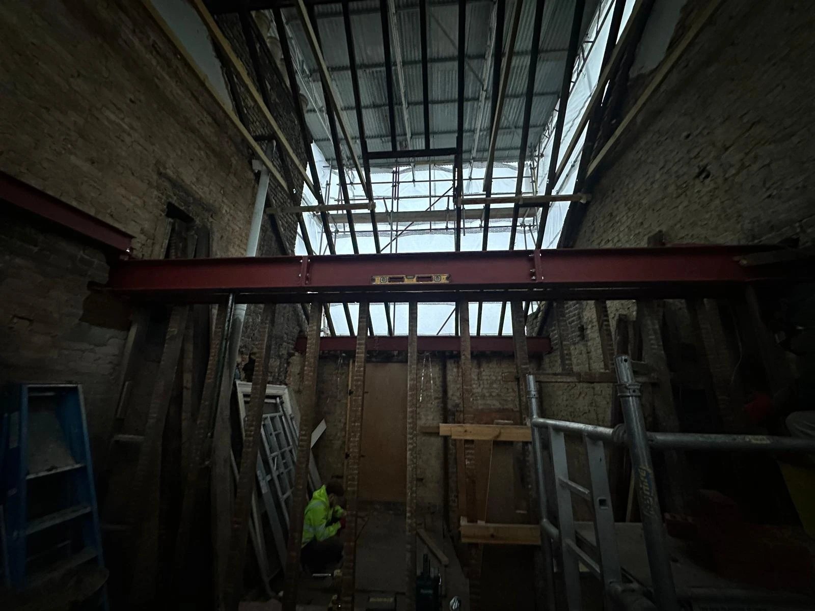 New steel beam set level across a stripped back house